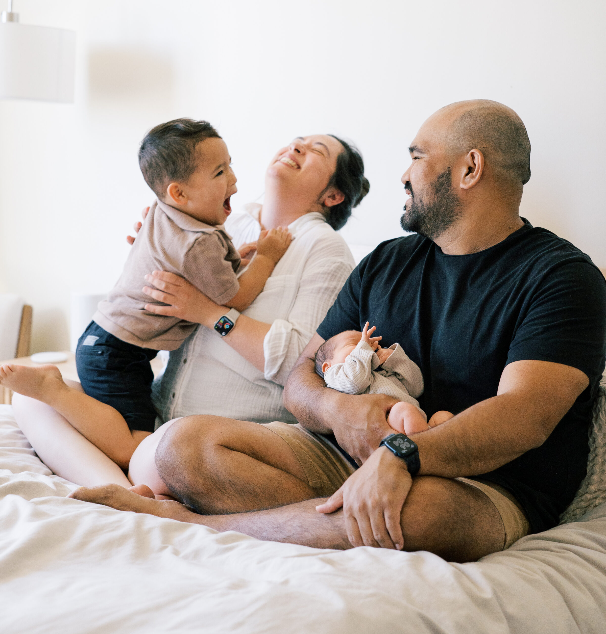 A family laughing during their in-home photography session.